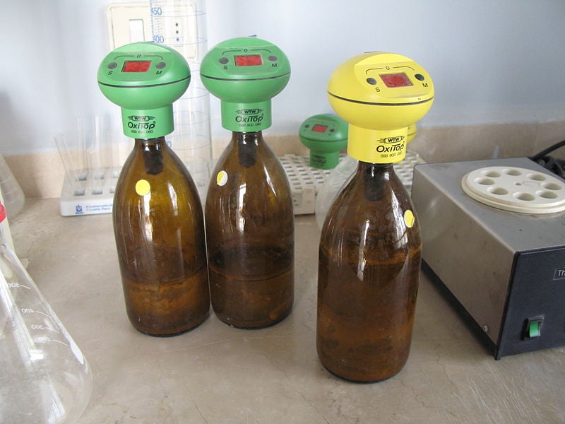 Laboratory biochemical oxygen demand bottles with digital meters placed on top.